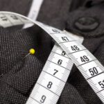 close up of measuring tape used in custom suit creation
