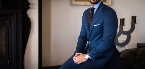 Man in his expensive tailored suit on a couch