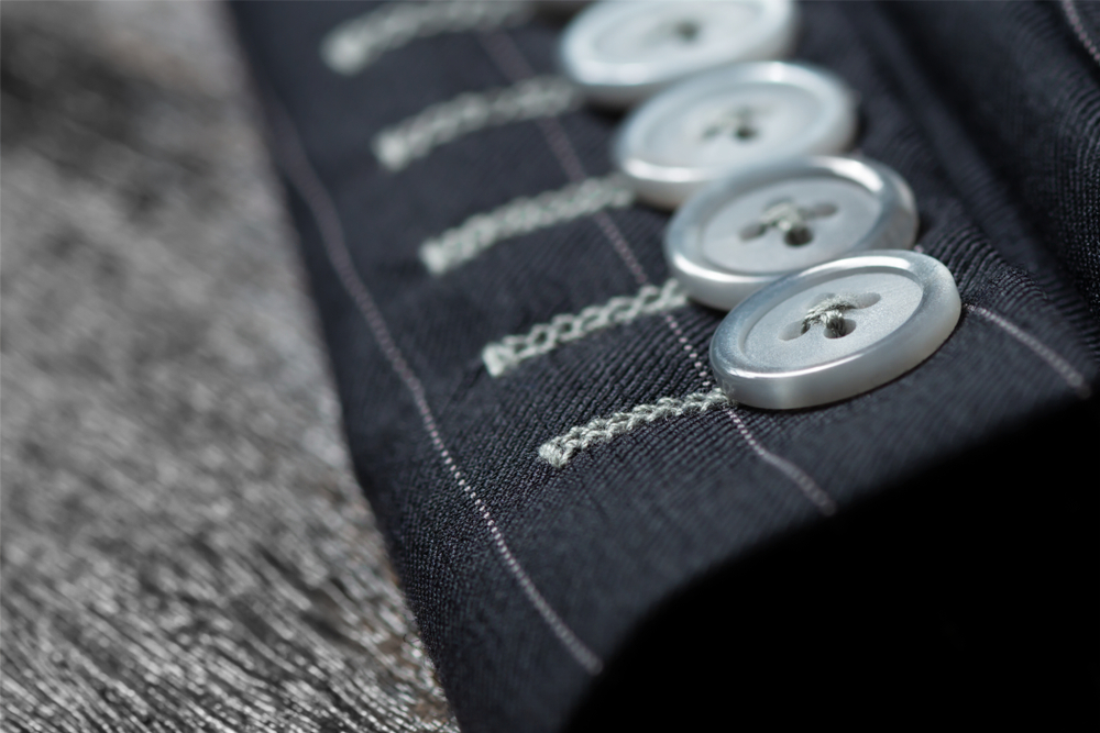 Close up detail of sleeve buttons and stitching
