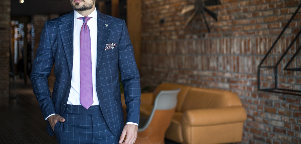 Man in expensive custom-tailored suit posing
